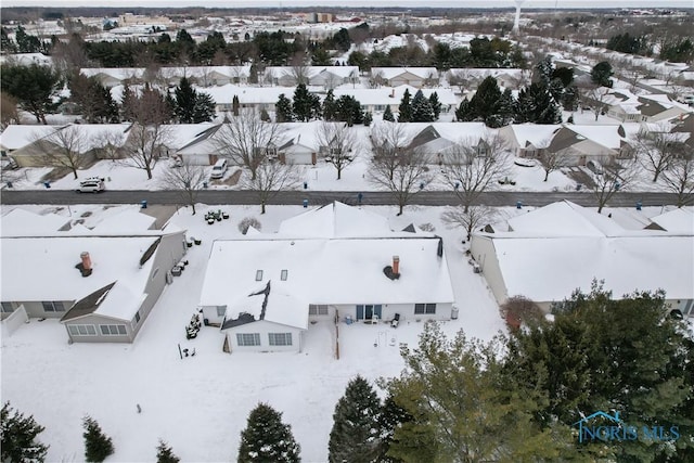 snowy aerial view featuring a residential view