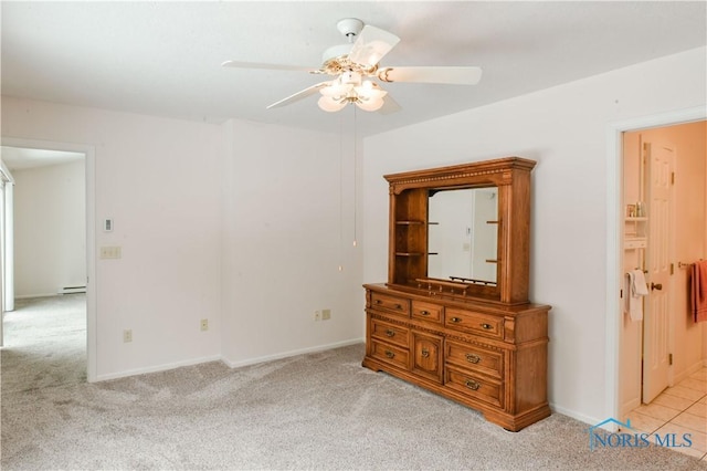 unfurnished bedroom with a ceiling fan, carpet, baseboards, and a baseboard radiator