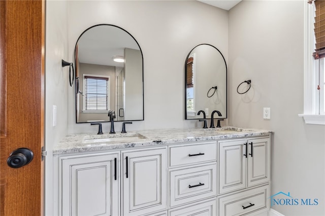 full bath with double vanity and a sink