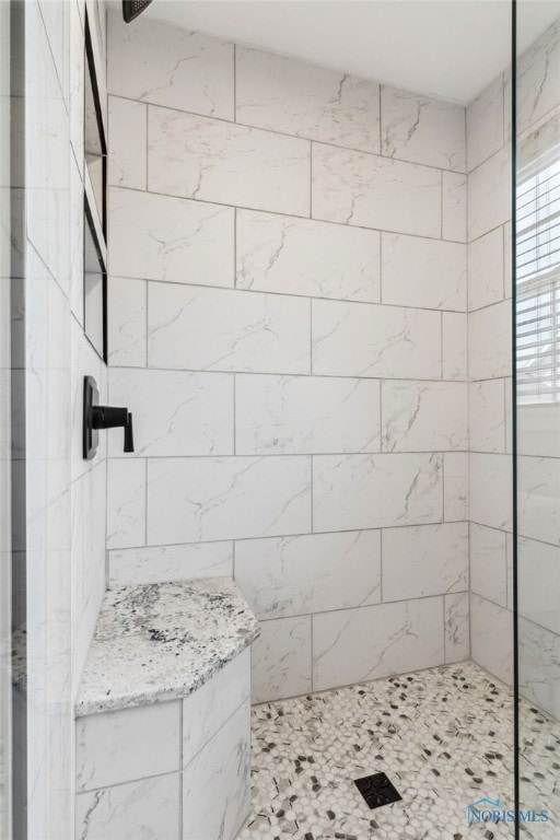 bathroom with a tile shower