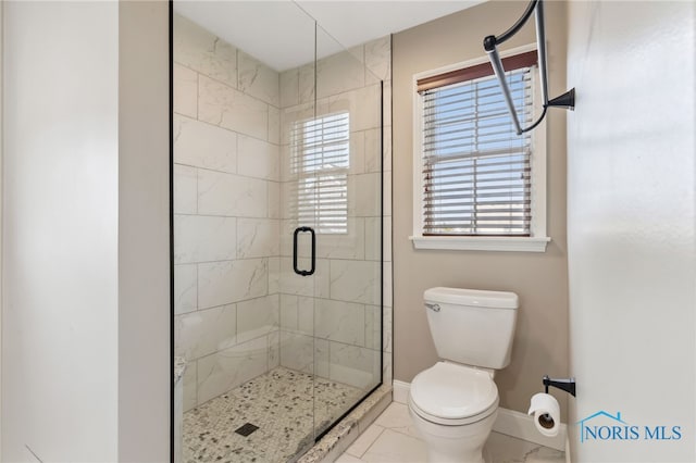 full bath featuring toilet, a stall shower, baseboards, and marble finish floor