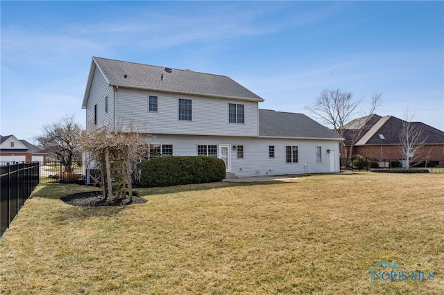 back of property featuring a patio area, a yard, a fenced backyard, and roof with shingles