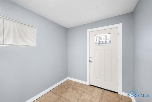 entryway featuring light tile patterned floors and baseboards