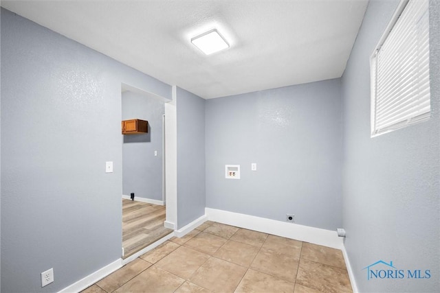 laundry room with washer hookup, laundry area, baseboards, and light tile patterned floors