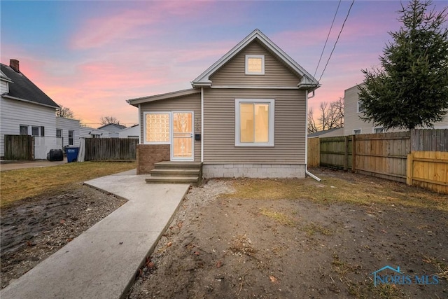 back of house with entry steps and fence