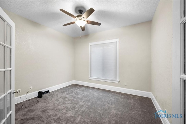 carpeted empty room featuring ceiling fan, baseboards, a textured ceiling, and french doors