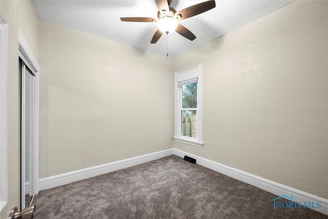 empty room featuring carpet and baseboards