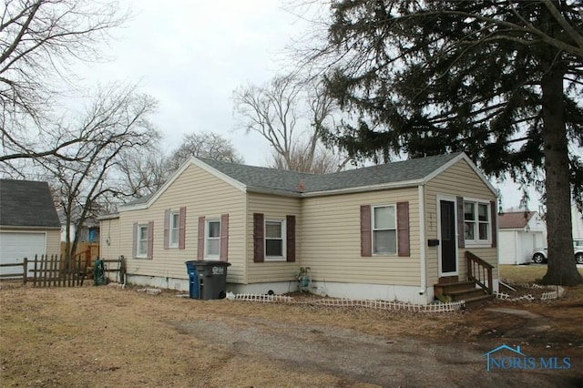 view of front of home with entry steps and fence