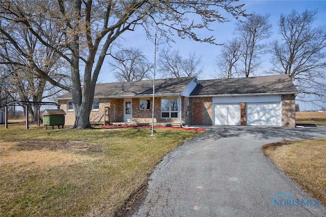 ranch-style home with brick siding, driveway, a front lawn, and a garage