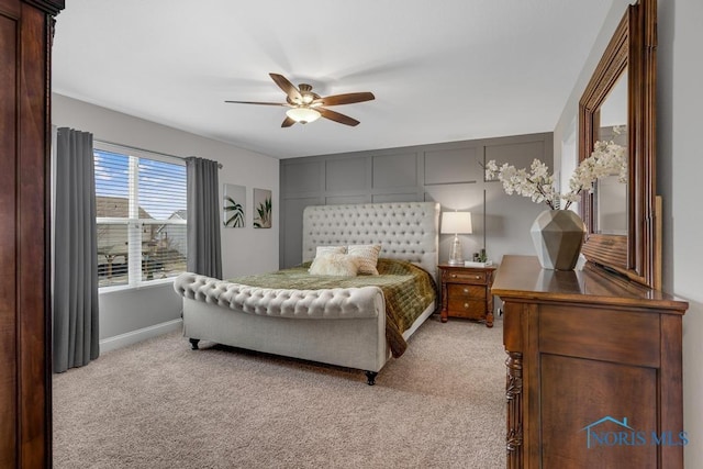 bedroom featuring light carpet, ceiling fan, and baseboards