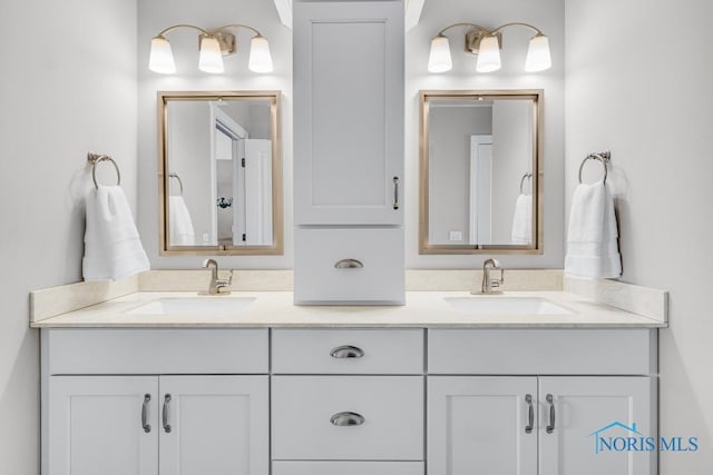 full bathroom featuring a sink and double vanity