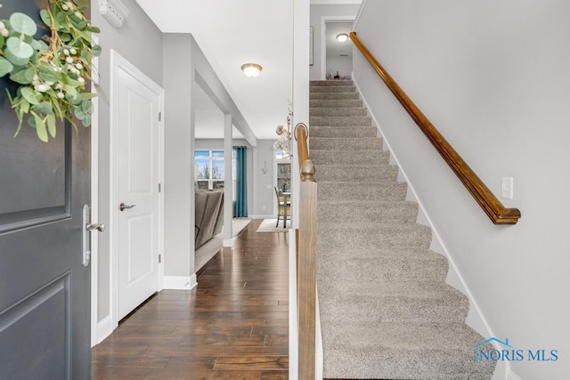 stairs featuring baseboards and wood finished floors