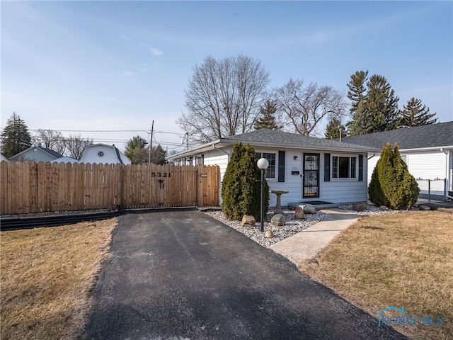 view of front of home featuring fence and a front lawn