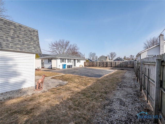 view of yard featuring an outbuilding and a fenced backyard