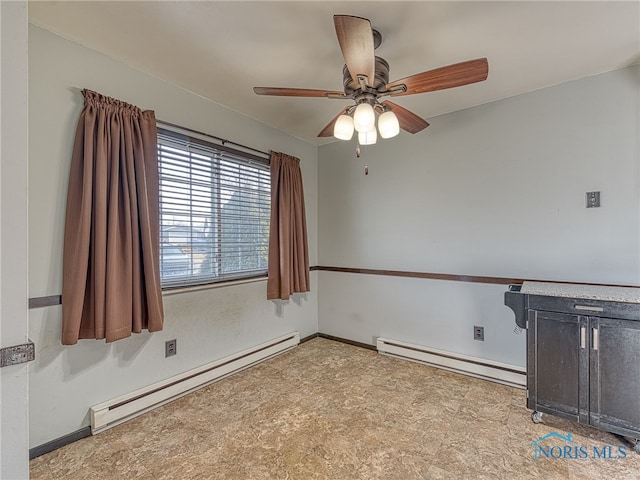 spare room featuring a baseboard radiator, ceiling fan, and baseboards