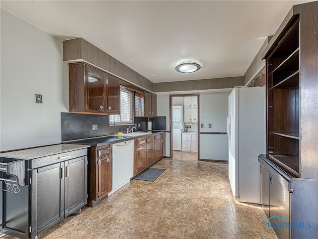 kitchen featuring white appliances, a sink, and open shelves