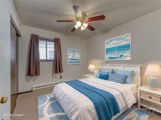 carpeted bedroom featuring a baseboard radiator, ceiling fan, and a textured ceiling