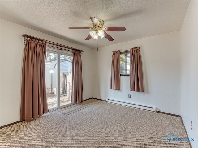 spare room featuring light carpet, baseboards, a baseboard heating unit, and a textured ceiling