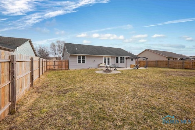 back of property with a patio, a lawn, and a fenced backyard