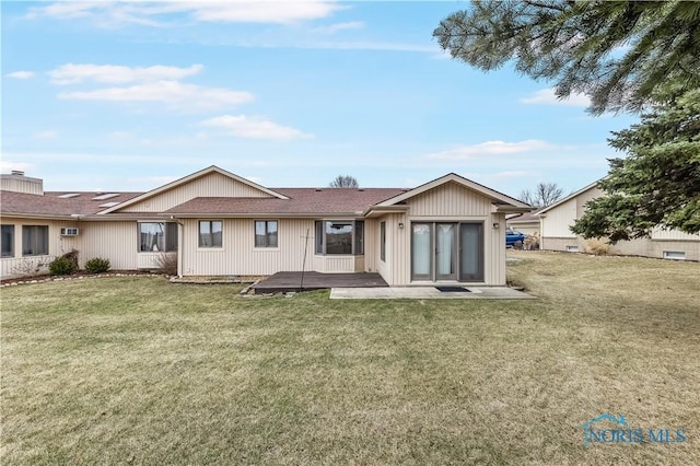 rear view of property featuring a yard