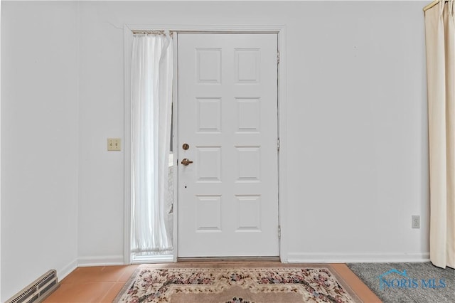 foyer with light tile patterned floors, visible vents, and baseboards