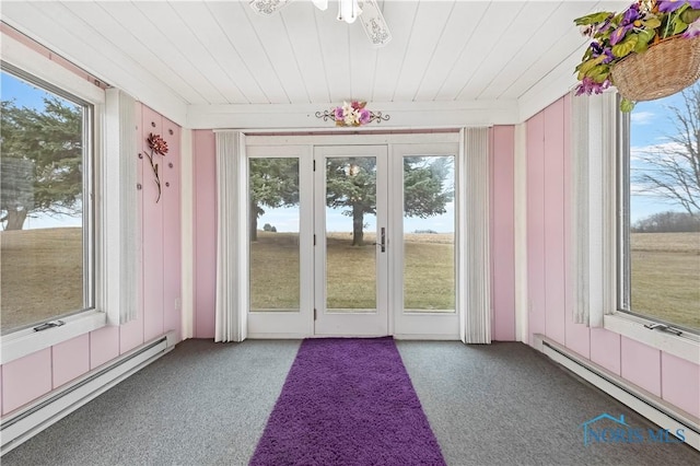 unfurnished sunroom featuring plenty of natural light, wood ceiling, and baseboard heating