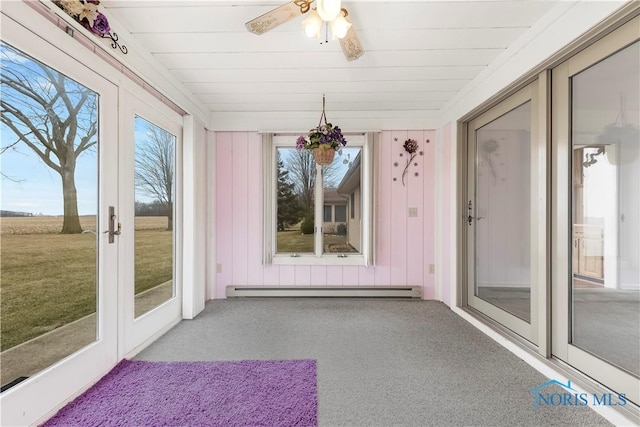 unfurnished sunroom with ceiling fan, french doors, baseboard heating, and wood ceiling