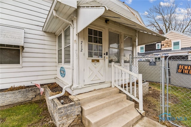 property entrance with fence and a gate