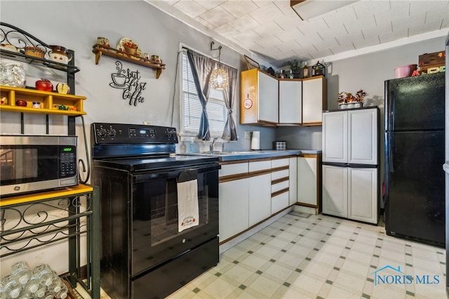 kitchen with light floors, open shelves, a sink, white cabinetry, and black appliances