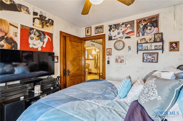 bedroom with arched walkways and ceiling fan