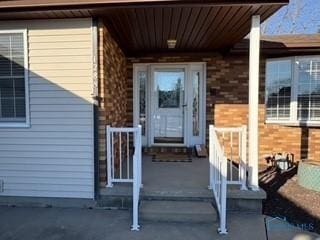 entrance to property with brick siding