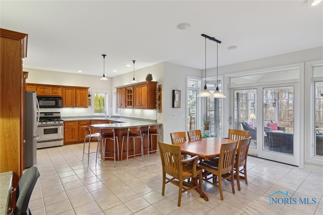 dining area featuring light tile patterned floors and recessed lighting