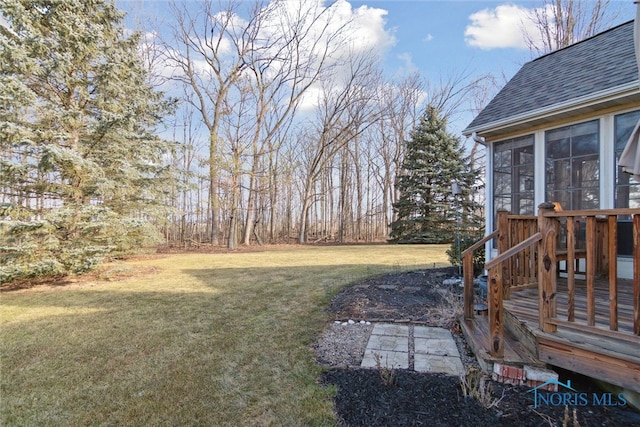 view of yard featuring a sunroom