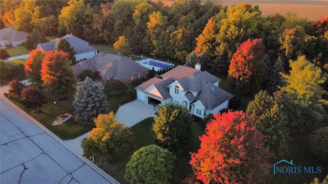 aerial view featuring a wooded view