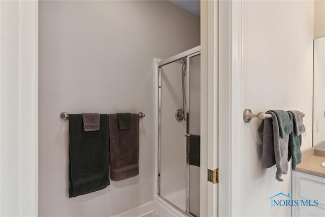 full bathroom with a shower stall and vanity