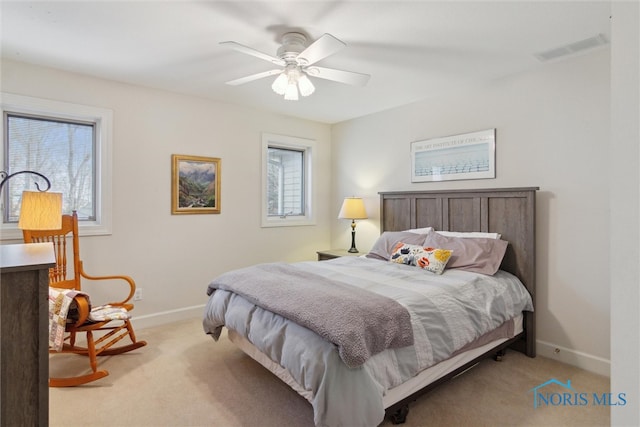 bedroom featuring light carpet, a ceiling fan, visible vents, and baseboards