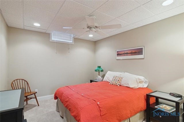 carpeted bedroom with a ceiling fan, a paneled ceiling, baseboards, and recessed lighting