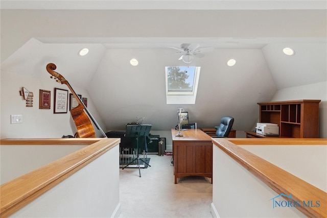 office area featuring light carpet, vaulted ceiling with skylight, ceiling fan, and recessed lighting