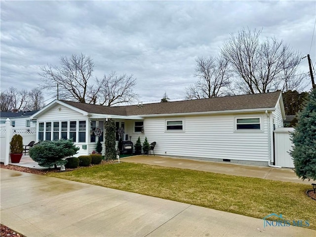 single story home featuring a front lawn, a patio area, and fence