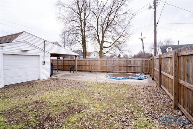 view of yard with an outbuilding, a patio, and a fenced backyard