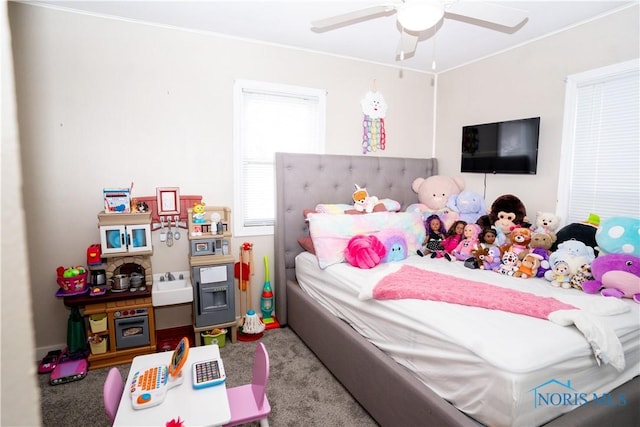 carpeted bedroom with ceiling fan and ornamental molding