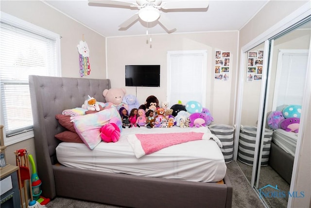 bedroom featuring multiple windows, a closet, and a ceiling fan