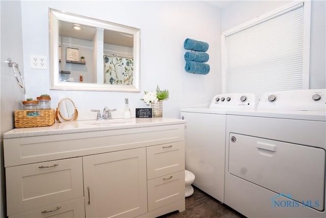 laundry room with a sink and separate washer and dryer