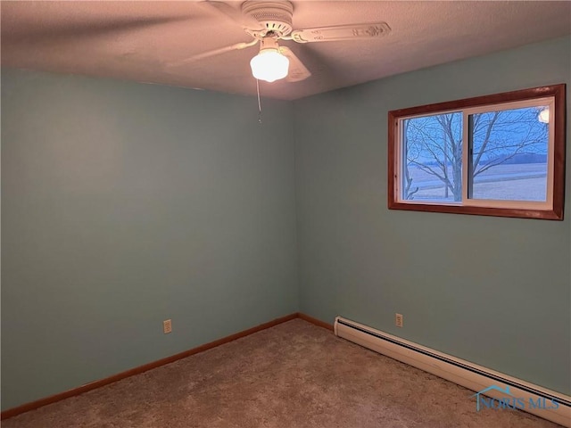 empty room with carpet floors, baseboards, a baseboard heating unit, and ceiling fan