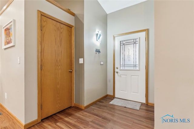 entryway featuring light wood-type flooring and baseboards