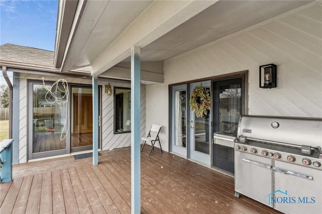 wooden deck featuring a grill