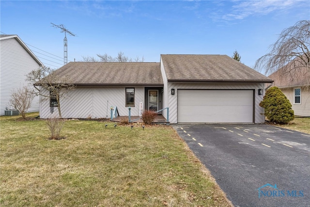 view of front of property with a shingled roof, a front yard, a garage, cooling unit, and driveway