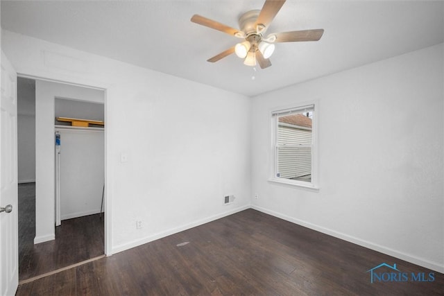 unfurnished bedroom featuring wood finished floors, visible vents, and baseboards