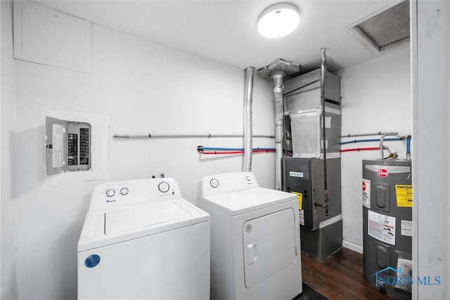 clothes washing area with laundry area, attic access, dark wood finished floors, independent washer and dryer, and water heater