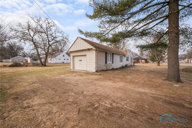 view of side of home featuring board and batten siding and dirt driveway